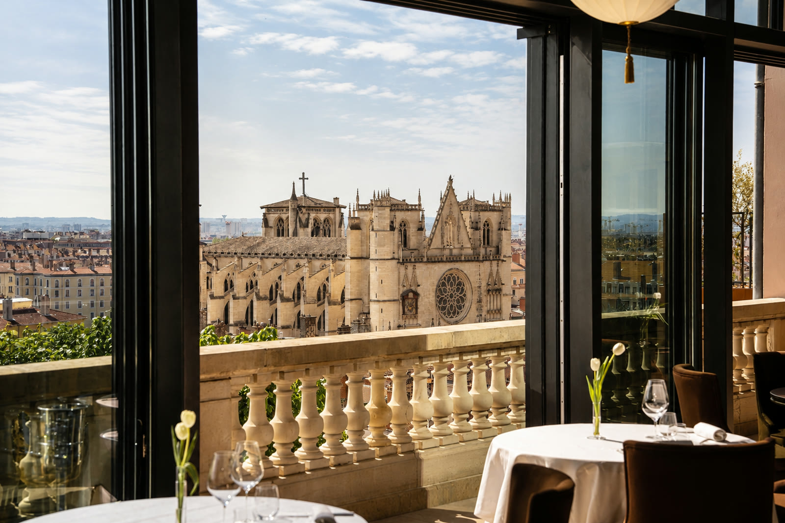 The terrace tables of La Table de la Villa Florentine, the cathedral of Saint-Jean across the rooftops of Vieux Lyon