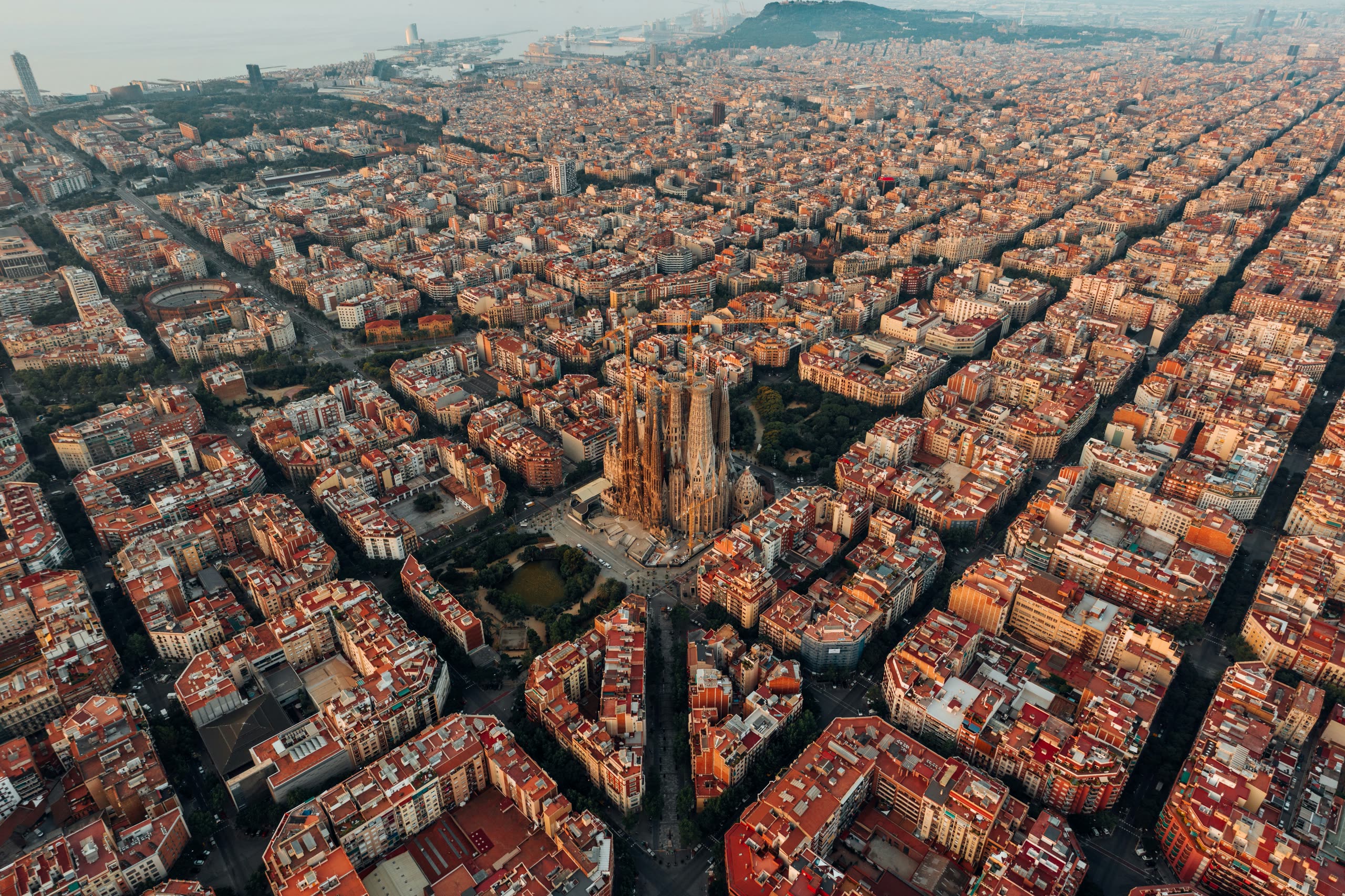 Barcelona from the air at first light, the Sagrada Família rising from the Eixample grid